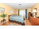 Cozy primary bedroom with wood floors, large windows, and plenty of natural light at 4501 N Wheeling Ave # 10A-101, Muncie, IN 47304