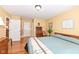 Primary bedroom with neutral paint, wood floors, and two closets at 4501 N Wheeling Ave # 10A-101, Muncie, IN 47304