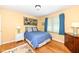 Bright bedroom with a double bed, light yellow walls, and hardwood floors at 4501 N Wheeling Ave # 10A-101, Muncie, IN 47304