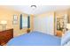 Cozy bedroom featuring hardwood floors, closet, and access to the laundry room at 4501 N Wheeling Ave # 10A-101, Muncie, IN 47304