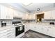 Bright kitchen features white cabinets, modern appliances, and a window with a view to the living area at 4501 N Wheeling Ave # 10A-101, Muncie, IN 47304