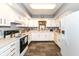 Well-lit kitchen with white cabinets, modern appliances, and ample counter space at 4501 N Wheeling Ave # 10A-101, Muncie, IN 47304