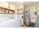 Functional laundry room equipped with washer, dryer, utility sink, and water heater at 4501 N Wheeling Ave # 10A-101, Muncie, IN 47304