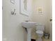 Charming powder room with pedestal sink, toilet, and delightful giraffe artwork at 4805 N Park Ave, Indianapolis, IN 46205
