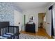 Bright Bedroom featuring hardwood floors, patterned wallpaper, and dark wood furnishings at 4805 N Park Ave, Indianapolis, IN 46205