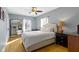 Bedroom with hardwood floors, a queen-size bed, an ornate mirror, and plentiful natural light at 4805 N Park Ave, Indianapolis, IN 46205