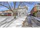 Well-maintained home with a cozy front porch, framed by a mature tree and snowy landscape at 4805 N Park Ave, Indianapolis, IN 46205