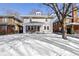 Charming two-story home with inviting front porch and snowy front yard, perfect for a Gathering at 4805 N Park Ave, Indianapolis, IN 46205