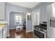 Kitchen with stainless steel appliances, adjacent dining area, and hardwood floors at 4805 N Park Ave, Indianapolis, IN 46205