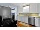Well-lit kitchen with stainless steel appliances, white cabinets, and hardwood floors at 4805 N Park Ave, Indianapolis, IN 46205