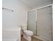 Bathroom featuring a walk-in shower, toilet, and tiled walls at 4912 Eagle Talon Ct, Indianapolis, IN 46254