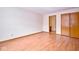 Spacious bedroom with wood-look floors, an ensuite, and closet for ample storage at 4912 Eagle Talon Ct, Indianapolis, IN 46254