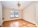 Dining room with natural light, wood floors, and modern chandelier fixture at 4912 Eagle Talon Ct, Indianapolis, IN 46254