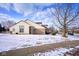 Well-kept home featuring a back deck, a large yard, and a serene, snow-covered neighborhood at 4912 Eagle Talon Ct, Indianapolis, IN 46254