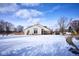 View of the home exterior shows siding, brick, and a spacious backyard, with mature trees on a sunny day at 4912 Eagle Talon Ct, Indianapolis, IN 46254