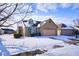 Charming brick home features an attached two-car garage and a snow-covered front yard at 4912 Eagle Talon Ct, Indianapolis, IN 46254
