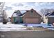 Brick home with attached garage is adorned with light snow, offering curb appeal at 4912 Eagle Talon Ct, Indianapolis, IN 46254