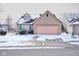 A well-maintained home with a brick facade and a two-car garage sits on a snow-dusted lot at 4912 Eagle Talon Ct, Indianapolis, IN 46254