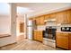Well-lit kitchen features wood cabinets, stainless steel appliances and tile floors at 4912 Eagle Talon Ct, Indianapolis, IN 46254