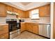 Classic kitchen featuring wood cabinetry, stainless steel appliances, and a cozy layout at 4912 Eagle Talon Ct, Indianapolis, IN 46254