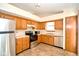 Bright kitchen boasts tile floors, wood cabinets, and stainless steel appliances at 4912 Eagle Talon Ct, Indianapolis, IN 46254
