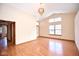 Bright living room showcases wood floors, vaulted ceilings, and an elegant light fixture at 4912 Eagle Talon Ct, Indianapolis, IN 46254