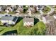 An aerial view shows a backyard with a deck and green grass in a suburban neighborhood on a sunny day at 5147 Nicodemus Dr, Plainfield, IN 46168