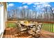 Back deck with seating overlooking manicured back lawn and tree line at 5147 Nicodemus Dr, Plainfield, IN 46168