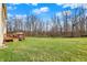 Spacious, well-maintained backyard with lawn and mature trees and a patio deck at 5147 Nicodemus Dr, Plainfield, IN 46168
