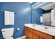 Bathroom with dual sinks, blue walls, and a large mirror at 5147 Nicodemus Dr, Plainfield, IN 46168