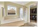 Bathroom features a tub, shower, and window providing natural light, with a walk-in closet at 5147 Nicodemus Dr, Plainfield, IN 46168