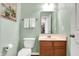 Powder room features a pedestal sink, toilet, and mirror with neutral paint color and decor at 5147 Nicodemus Dr, Plainfield, IN 46168
