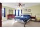 Bedroom with a black metal bed frame, ceiling fan, carpet, and natural light from the windows at 5147 Nicodemus Dr, Plainfield, IN 46168