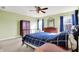 Bedroom with a black metal bed frame, ceiling fan, carpet, and natural light from the windows at 5147 Nicodemus Dr, Plainfield, IN 46168