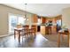 Bright dining area features wood table, hardwood floors, and connects to the modern kitchen at 5147 Nicodemus Dr, Plainfield, IN 46168