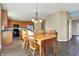 Dining area and kitchen featuring hardwood floors, stainless steel appliances, and ample lighting at 5147 Nicodemus Dr, Plainfield, IN 46168