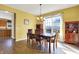 Bright dining room with wood floors, a chandelier, and large window overlooking the neighborhood at 5147 Nicodemus Dr, Plainfield, IN 46168
