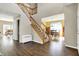 Spacious foyer with hardwood floors and staircase leading to the upper level, offering a view into the dining area at 5147 Nicodemus Dr, Plainfield, IN 46168