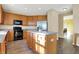 Modern kitchen with stainless steel appliances, center island, and beautiful wooden cabinets at 5147 Nicodemus Dr, Plainfield, IN 46168