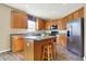Well-equipped kitchen with stainless steel appliances, island with seating, and hardwood floors at 5147 Nicodemus Dr, Plainfield, IN 46168