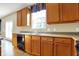 Kitchen countertop and cabinets are well lit with view of backyard through a window over the sink at 5147 Nicodemus Dr, Plainfield, IN 46168