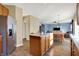 Kitchen with stainless steel refrigerator, central island, and open to the dining and living area at 5147 Nicodemus Dr, Plainfield, IN 46168