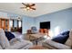 Cozy living room with comfortable seating, entertainment center, ceiling fan, and wood-look floors at 5147 Nicodemus Dr, Plainfield, IN 46168