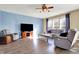 Relaxing living room features comfortable seating, a modern entertainment center, ceiling fan, and bright windows at 5147 Nicodemus Dr, Plainfield, IN 46168