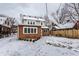A house with brick addition and manicured landscaping, showcasing its curb appeal in a snowy setting at 5715 N Delaware St, Indianapolis, IN 46220