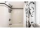 Bathroom with a shower-tub and updated fixtures and accessories at 5715 N Delaware St, Indianapolis, IN 46220