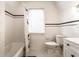Bathroom featuring a shower-tub combo with tiled walls and floors and a modern toilet and vanity at 5715 N Delaware St, Indianapolis, IN 46220
