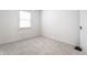 Bright bedroom with a large window offering ample natural light and neutral carpet at 5715 N Delaware St, Indianapolis, IN 46220