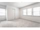 Bright bedroom featuring three windows with blinds and plush neutral carpeting at 5715 N Delaware St, Indianapolis, IN 46220