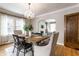 Dining room with wooden table, chandelier, and arched opening to living room at 5715 N Delaware St, Indianapolis, IN 46220